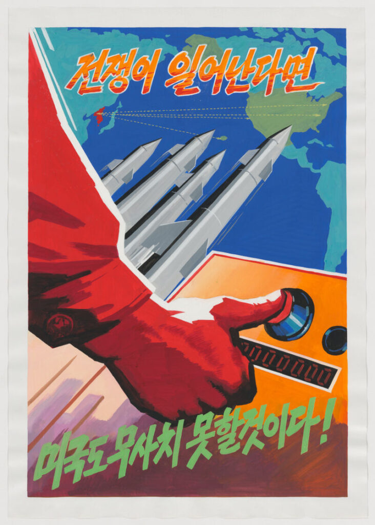 A red arm representing North Korea holds a thumb over a nuclear launch button